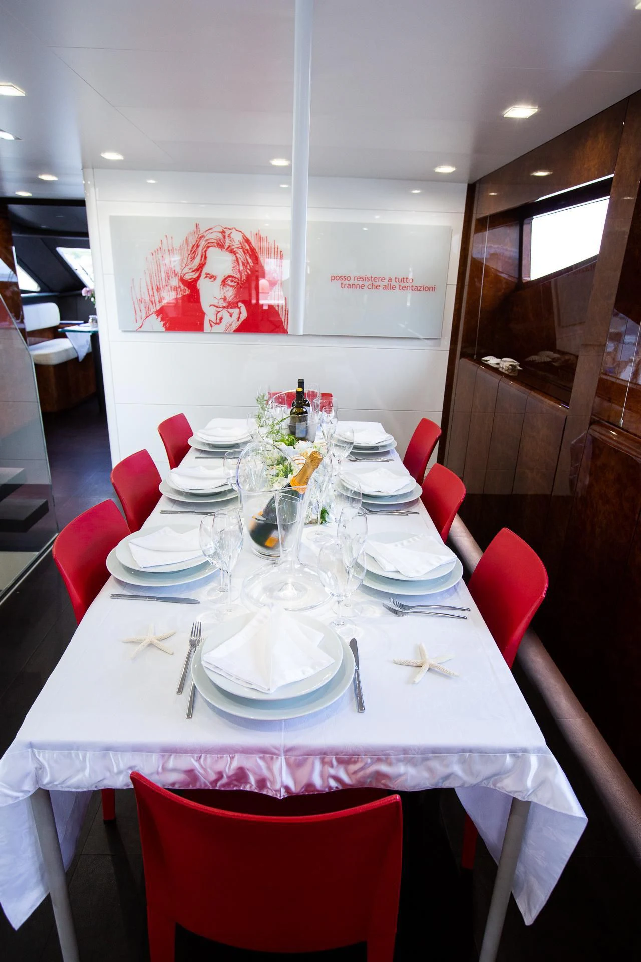 a table with plates and glasses on it aboard CAMILLA A Yacht for Sale