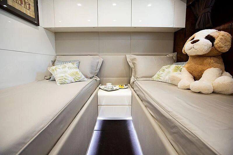 a stuffed bear next to a bed aboard CAMILLA A Yacht for Sale