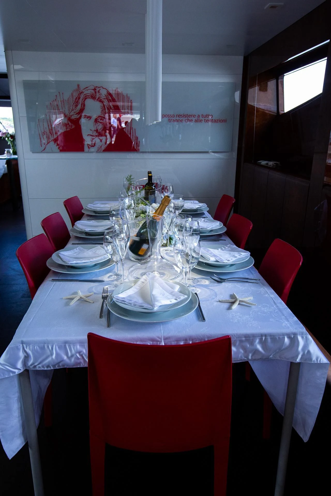 a table set with plates and glasses aboard CAMILLA A Yacht for Sale