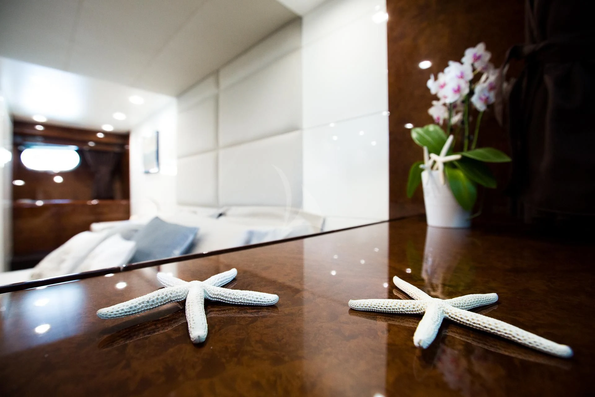 a vase with flowers on a table aboard CAMILLA A Yacht for Sale