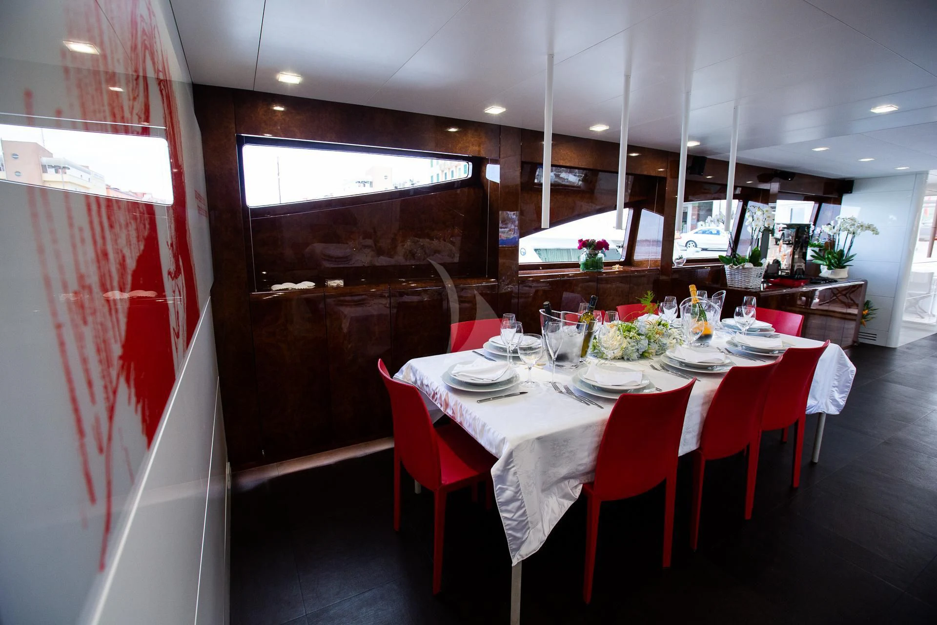 a restaurant with red tables aboard CAMILLA A Yacht for Sale