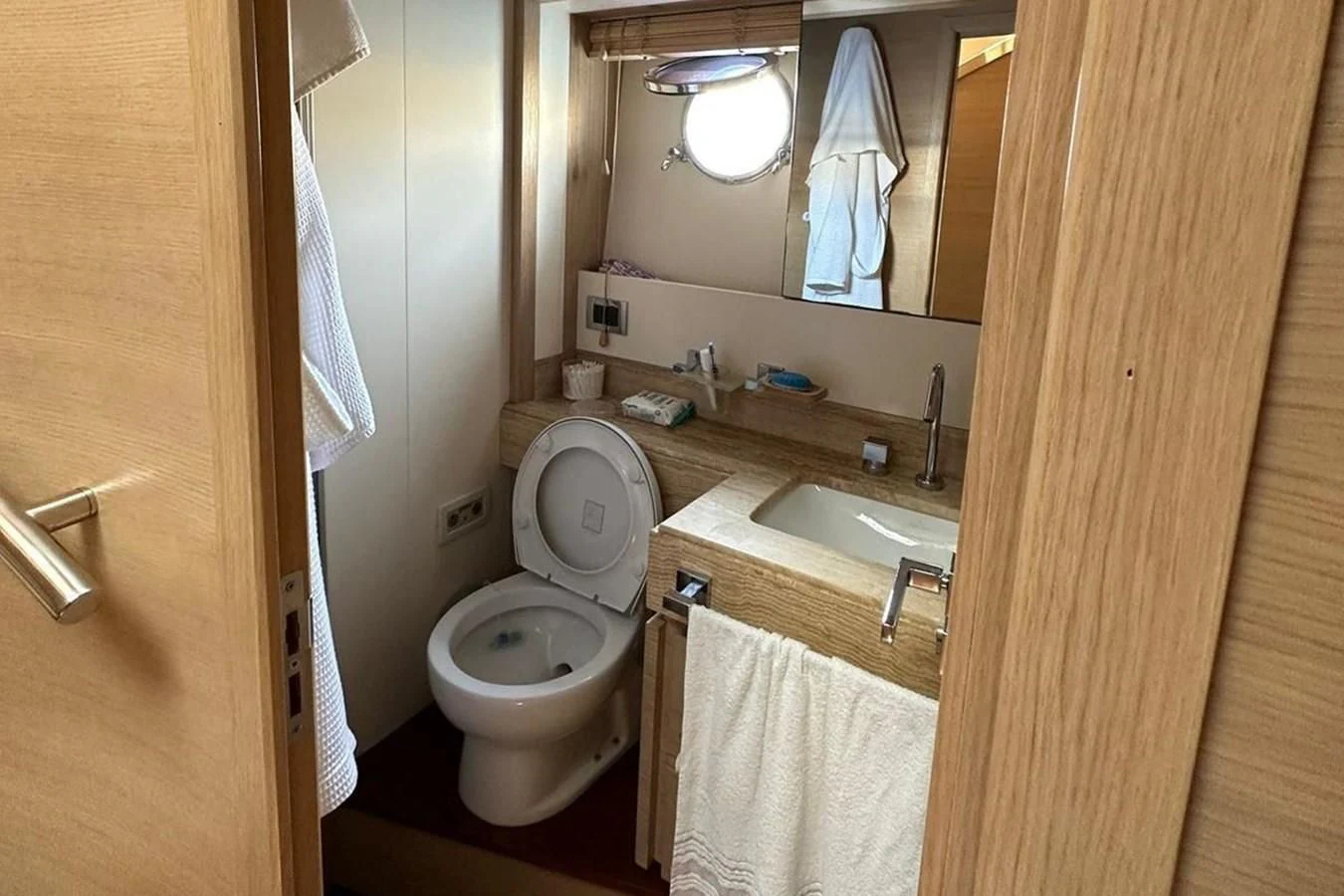 a bathroom with a toilet sink and a mirror aboard AZIMUT 84/12 Yacht for Sale
