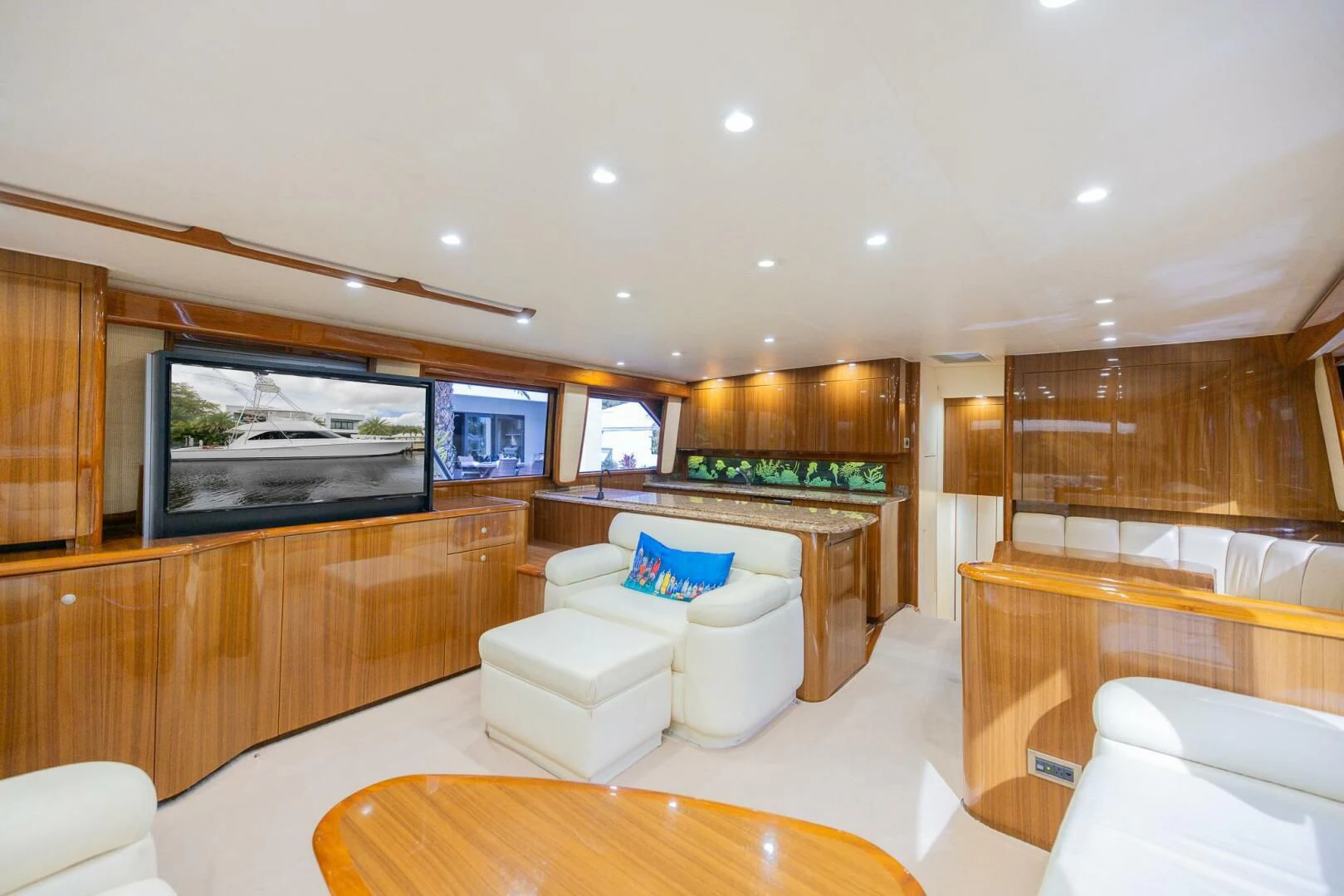 a large living room with a large screen aboard STABILIZED Yacht for Sale