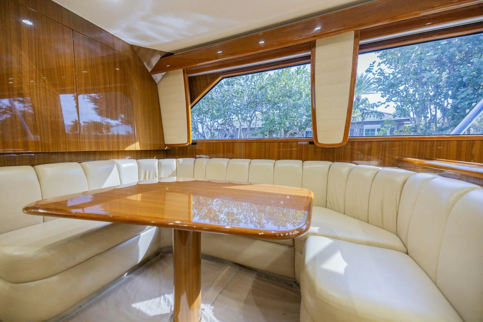 a room with a table and couch aboard STABILIZED Yacht for Sale
