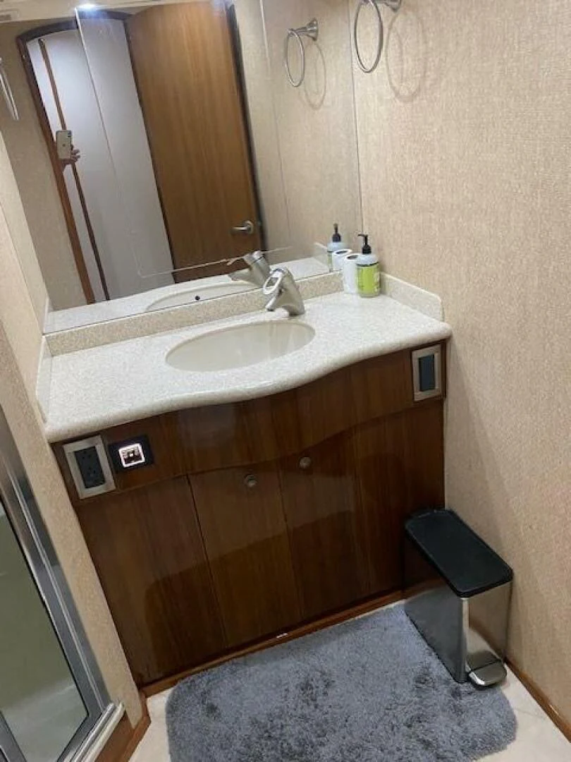 a bathroom with a sink and a mirror aboard STABILIZED Yacht for Sale