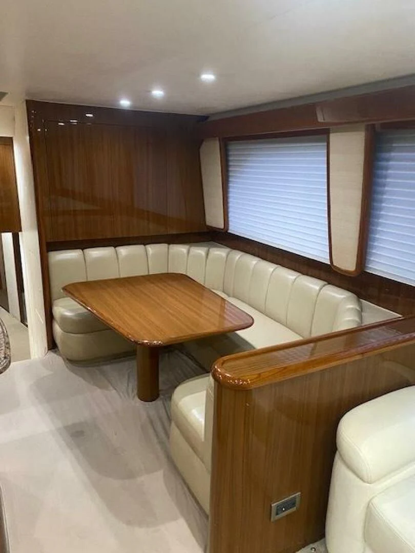 a room with a table and chairs aboard STABILIZED Yacht for Sale