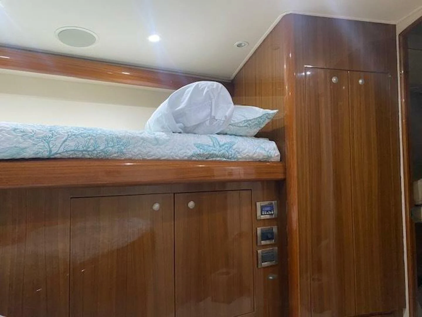 a bed with a white pillow aboard STABILIZED Yacht for Sale