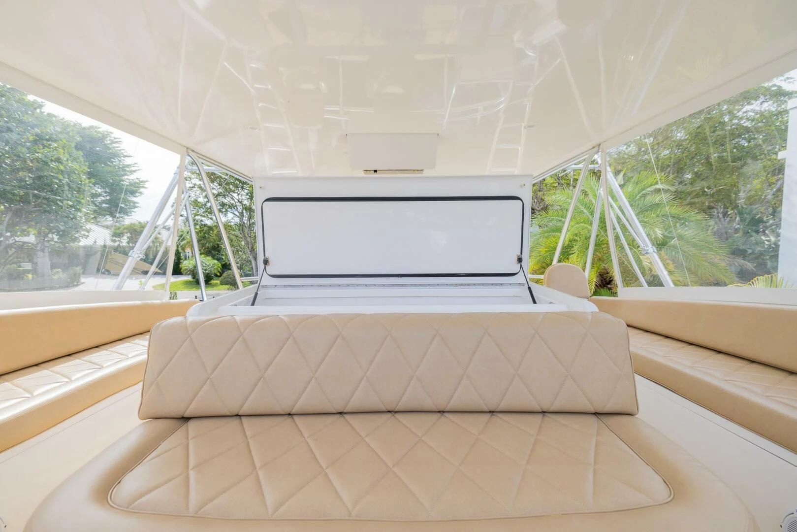 a white laptop on a wooden bench aboard STABILIZED Yacht for Sale