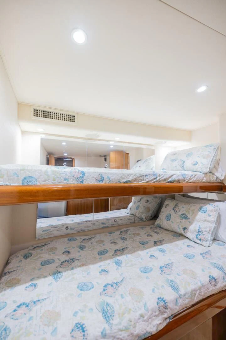 a bed with a blue blanket aboard STABILIZED Yacht for Sale