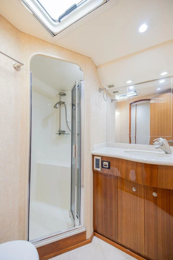 a bathroom with a shower unit and sink aboard STABILIZED Yacht for Sale