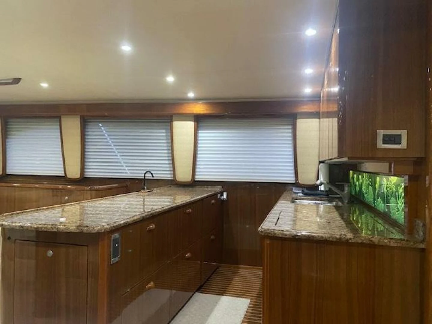 a kitchen with wooden cabinets aboard STABILIZED Yacht for Sale