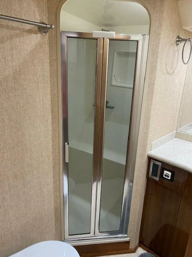 a bathroom with a glass shower aboard STABILIZED Yacht for Sale
