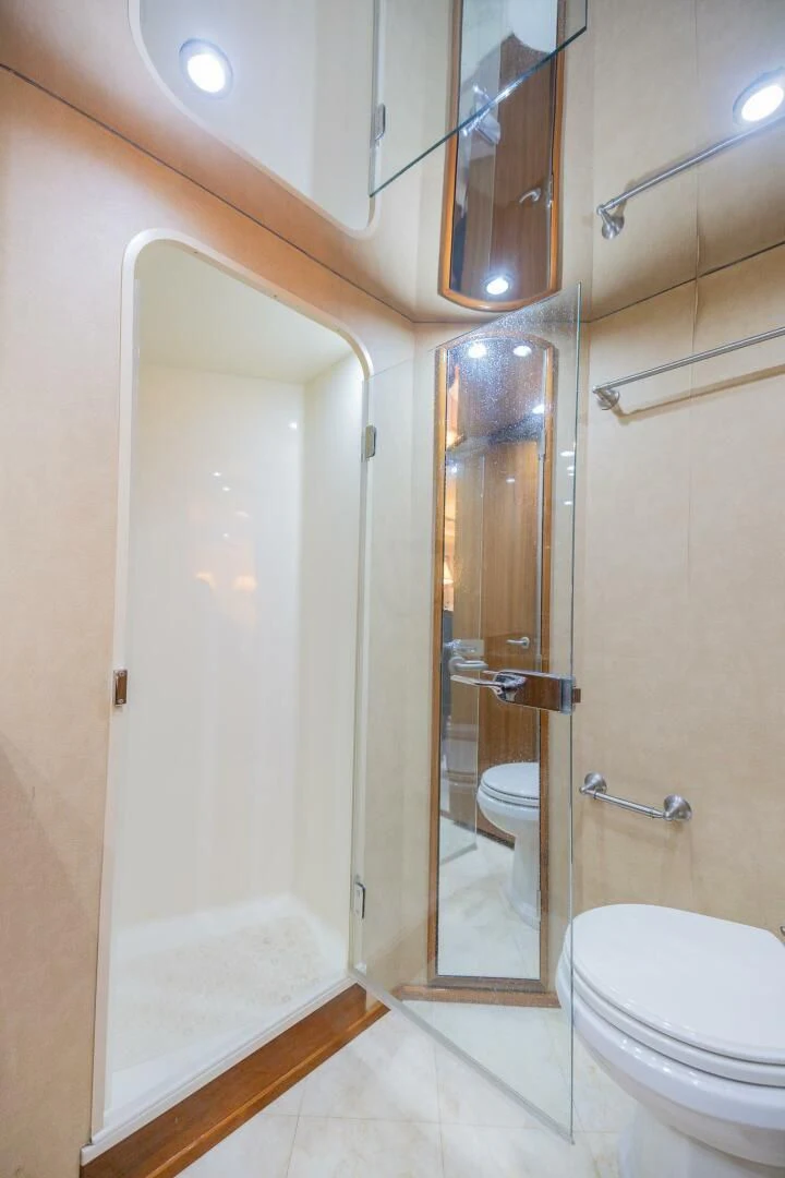 a bathroom with a glass shower door aboard STABILIZED Yacht for Sale