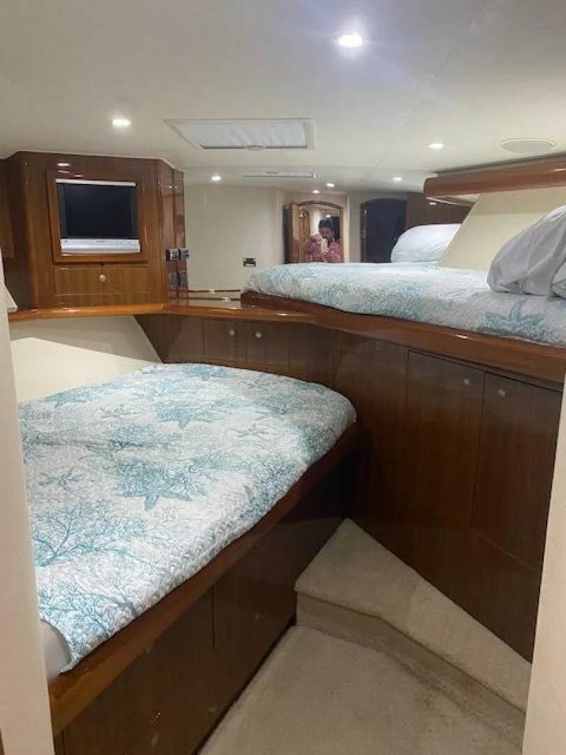 a bedroom with a bed and a television aboard STABILIZED Yacht for Sale
