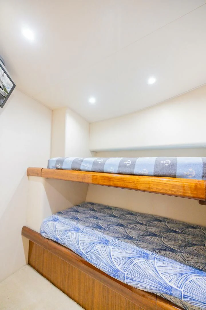 a room with a bed and a television aboard STABILIZED Yacht for Sale