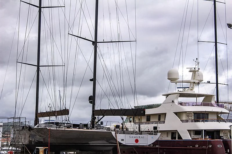 a large white boat sits in a harbor aboard SAMURAI Yacht for Sale