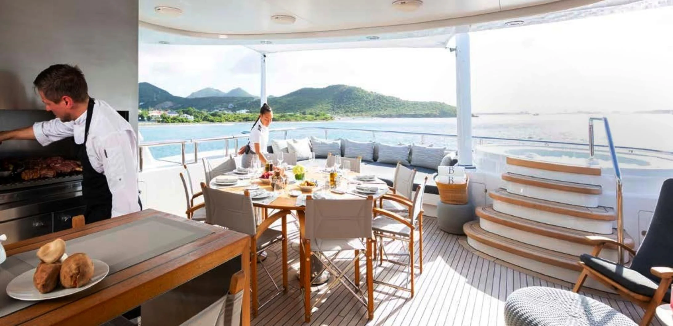 a man cooking on a boat aboard BRAVADO Yacht for Sale