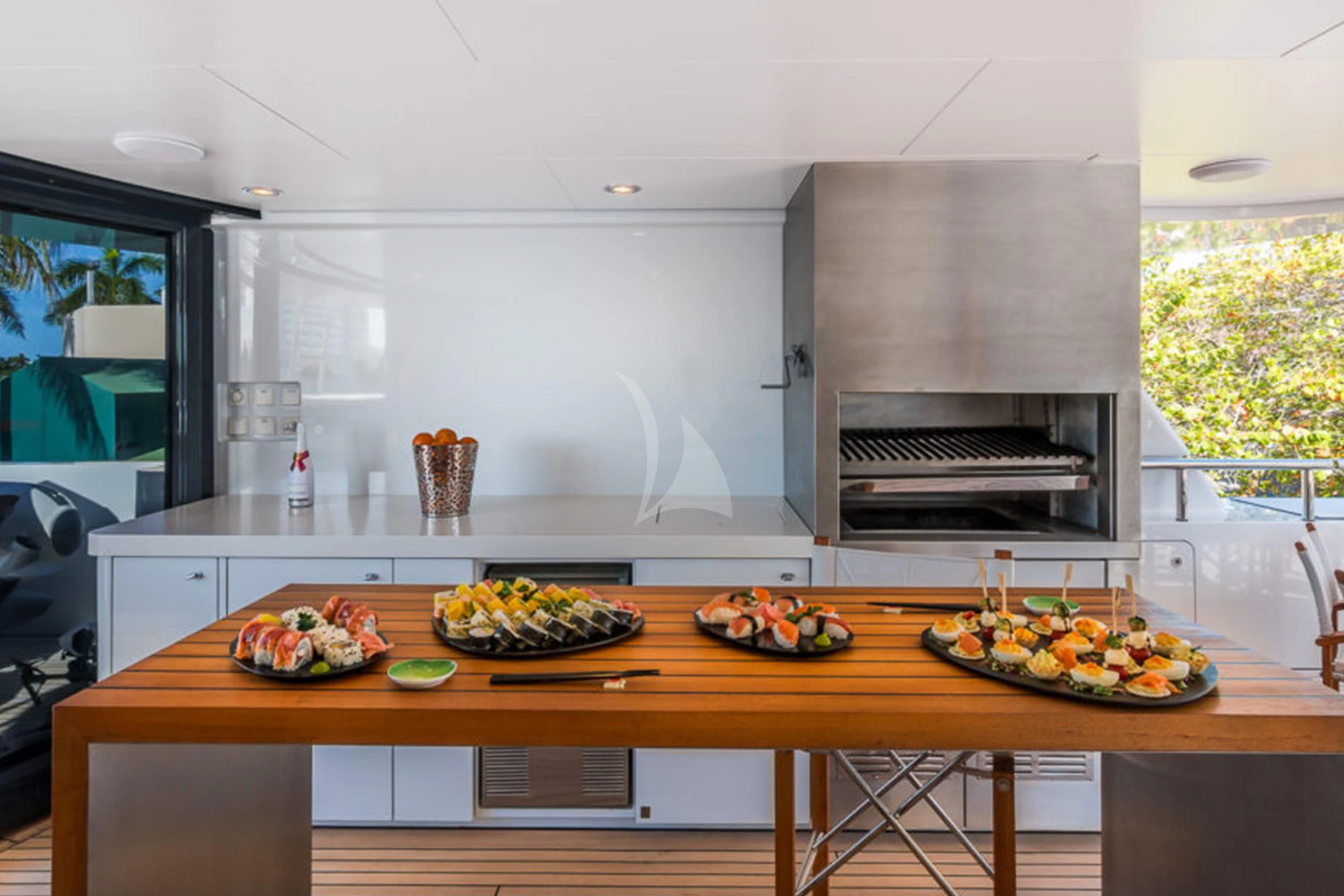 a kitchen with a table and plates aboard BRAVADO Yacht for Sale