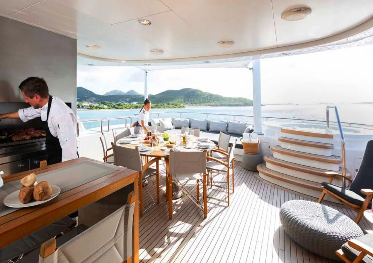 a person cooking on a boat aboard BRAVADO Yacht for Sale