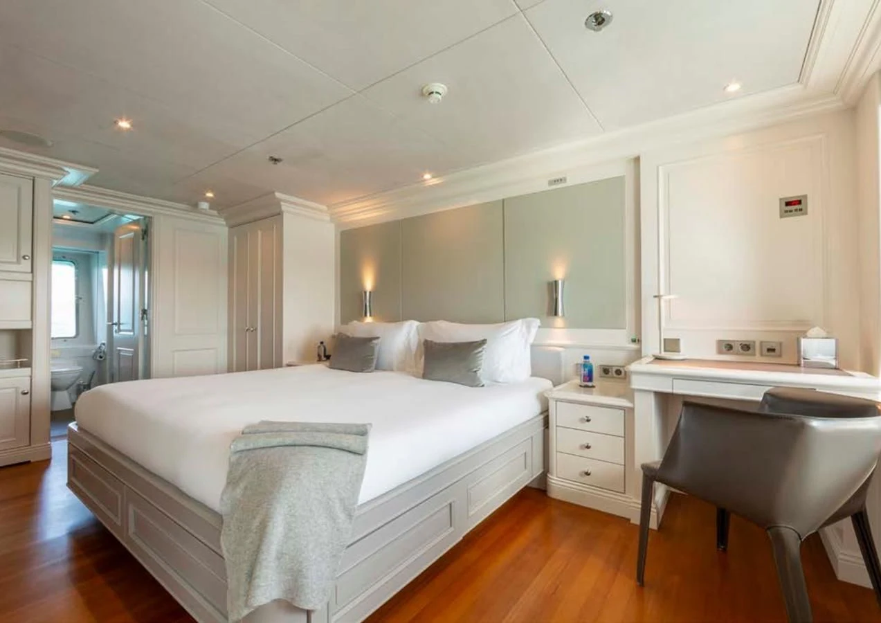 a large bedroom with a bed aboard BRAVADO Yacht for Sale