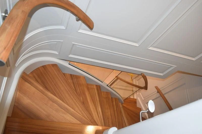 a wooden staircase with a white ceiling aboard BRAVADO Yacht for Sale