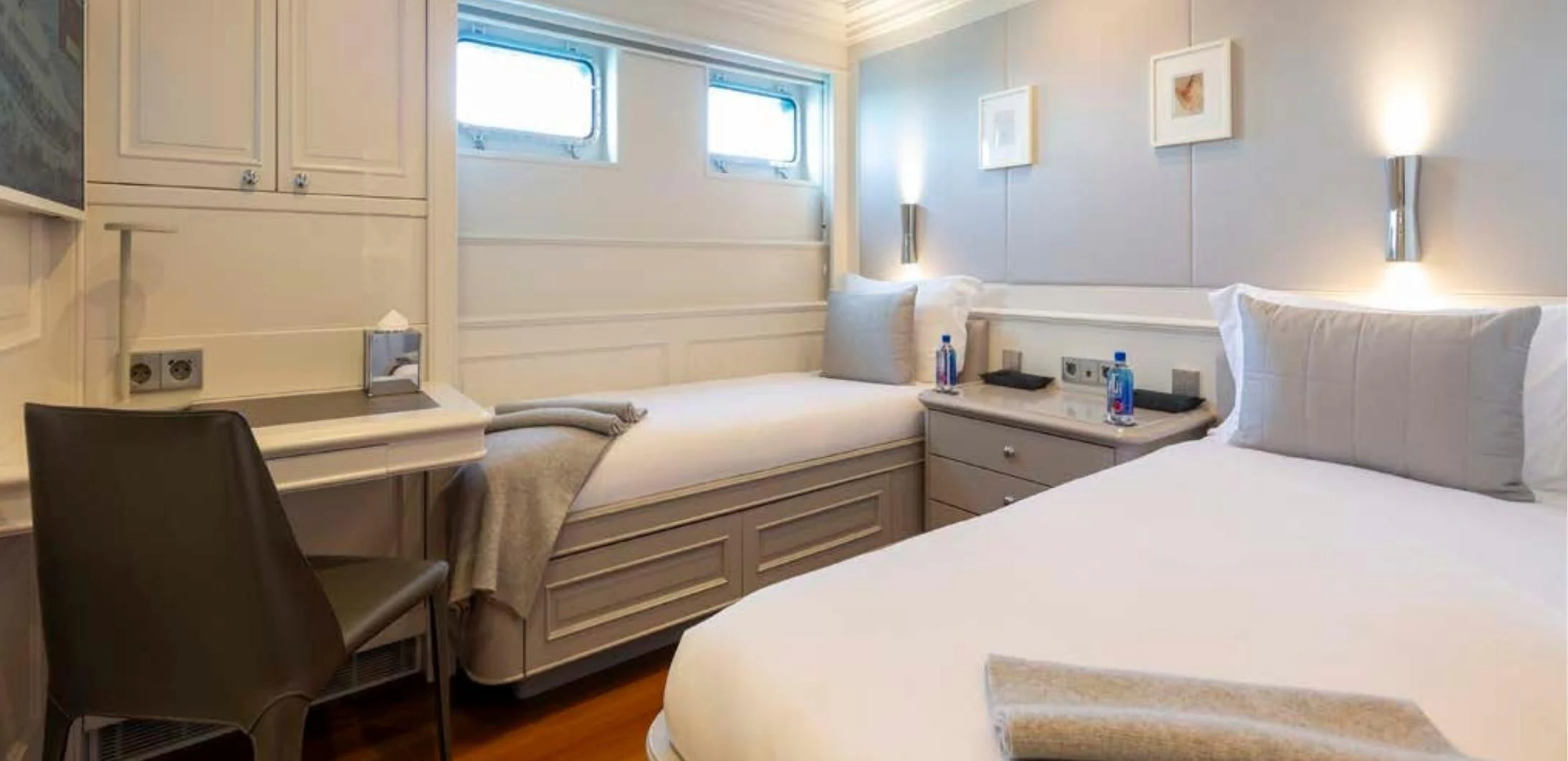 a room with a bed and a desk aboard BRAVADO Yacht for Sale
