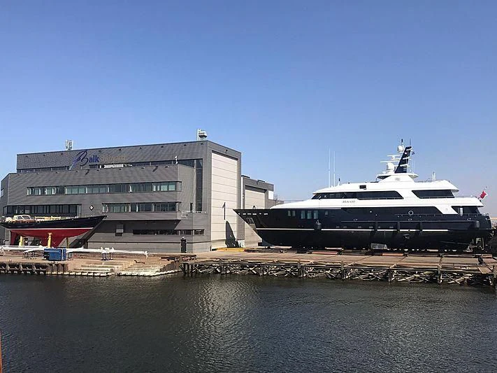 a large cruise ship docked aboard BRAVADO Yacht for Sale