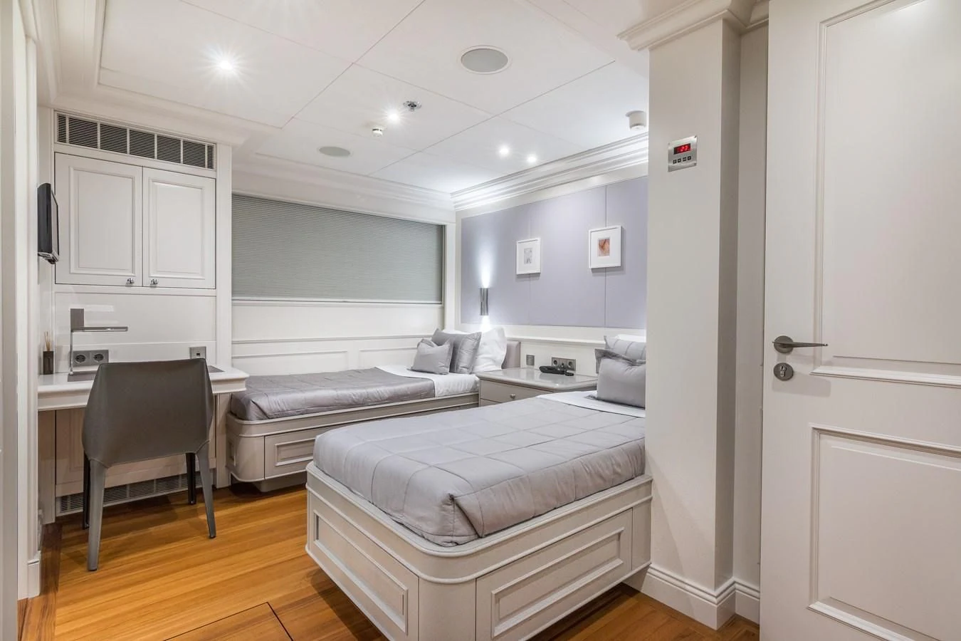 a bedroom with a bed and a desk aboard BRAVADO Yacht for Sale