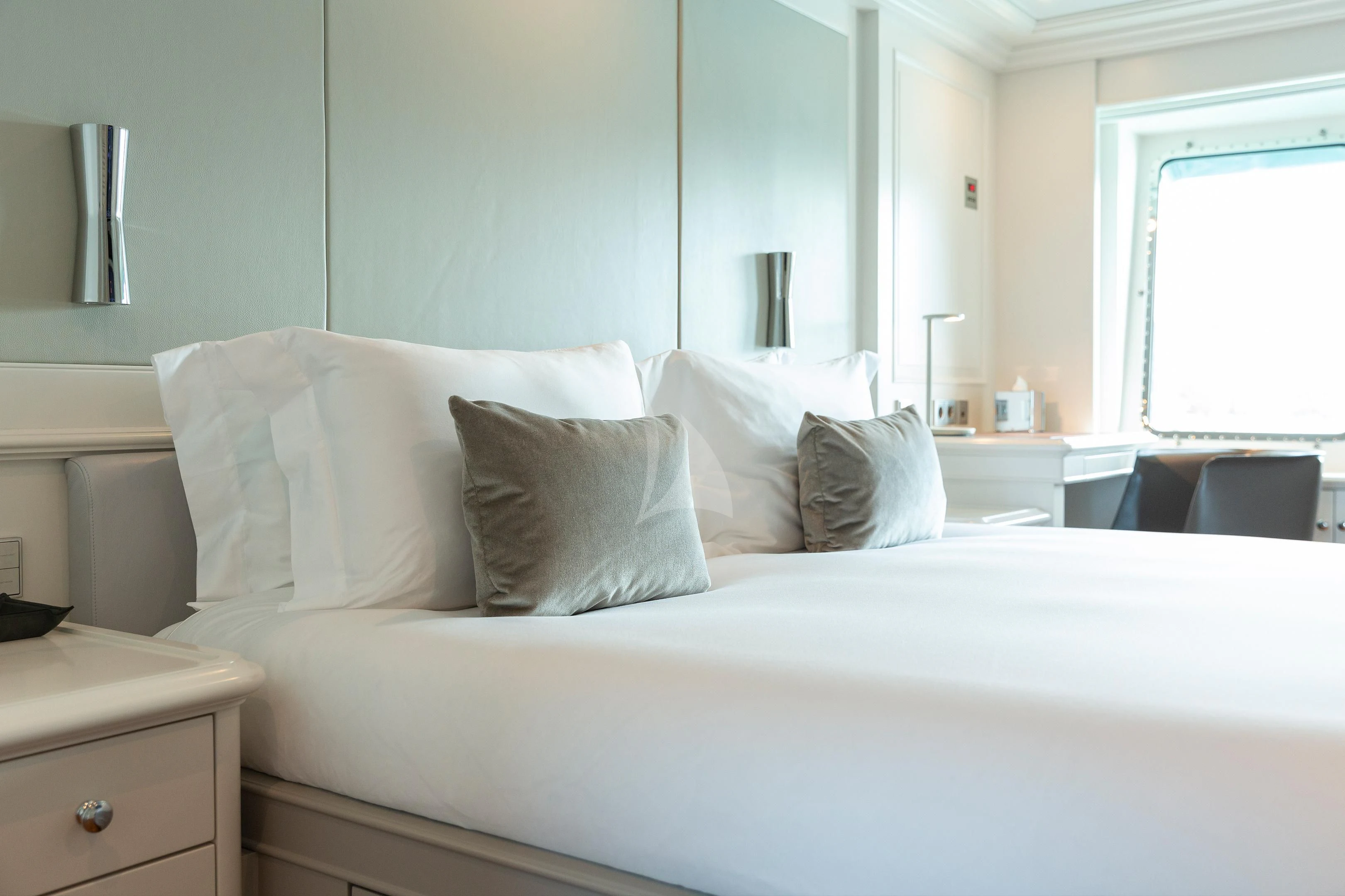 a bed with white sheets aboard BRAVADO Yacht for Sale