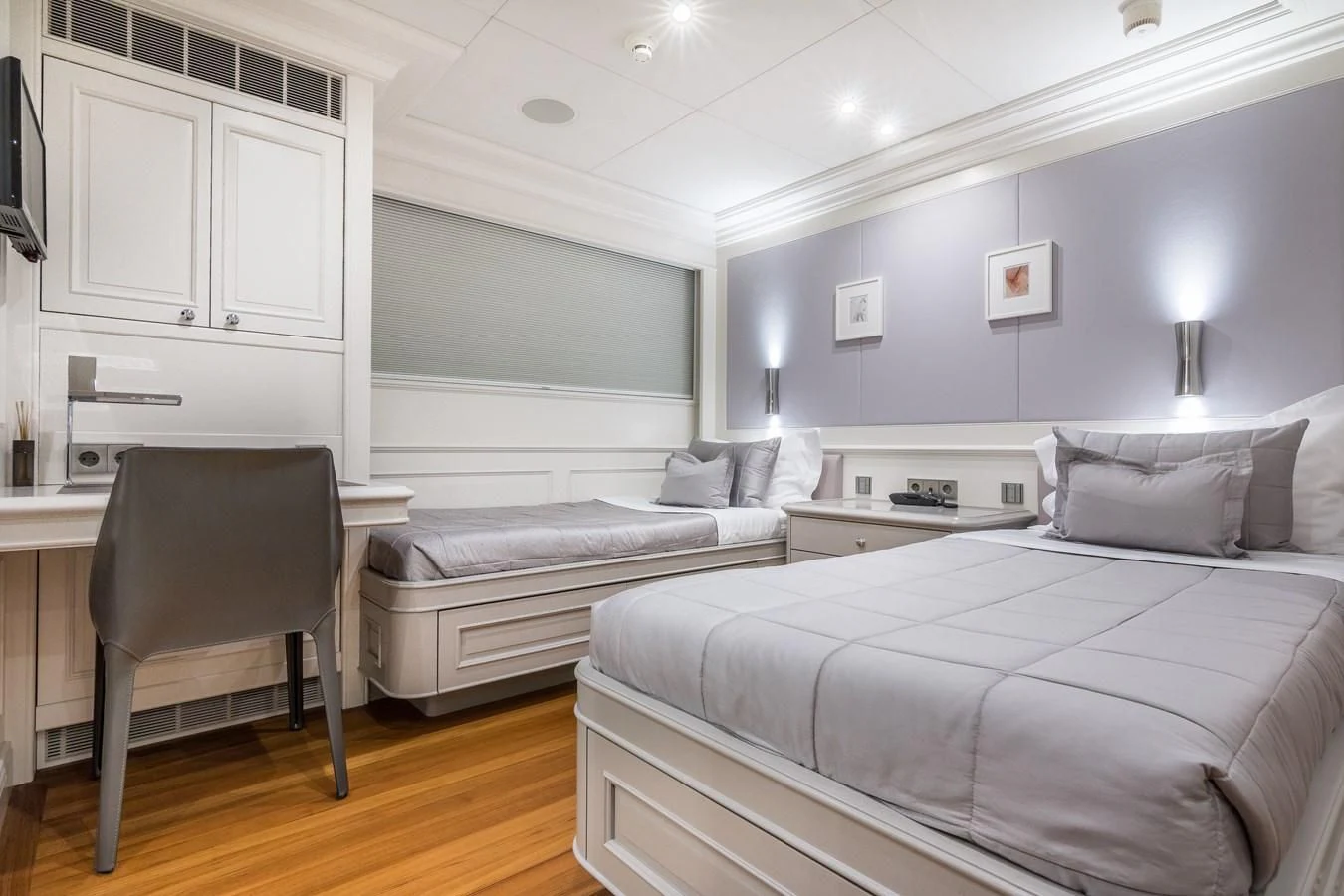 a bedroom with a bed and a chair aboard BRAVADO Yacht for Sale