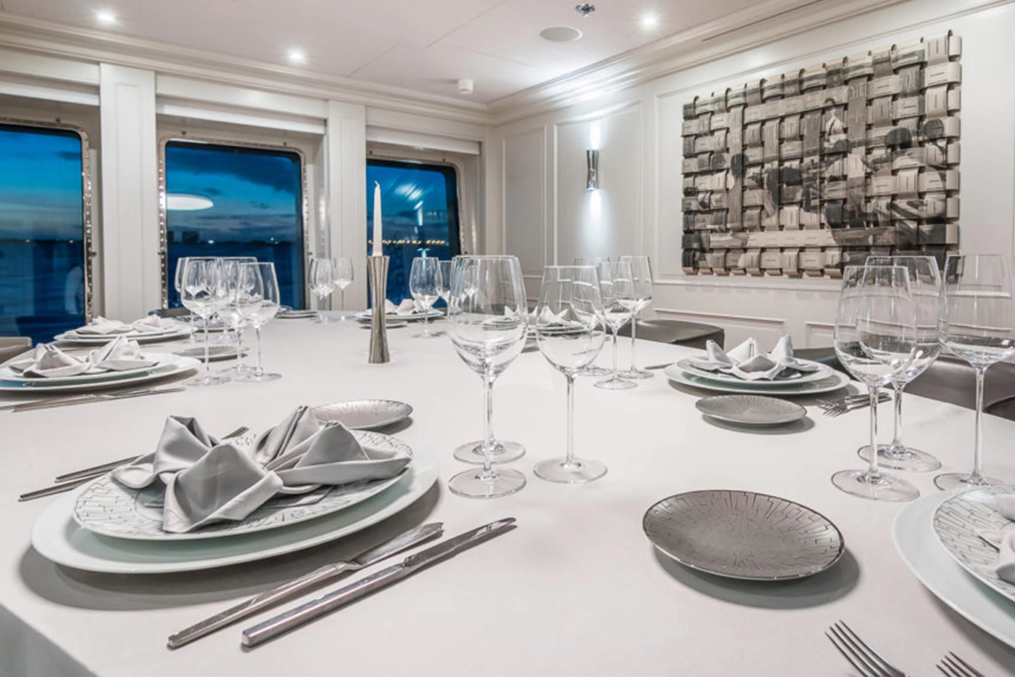 a table with plates and glasses aboard BRAVADO Yacht for Sale