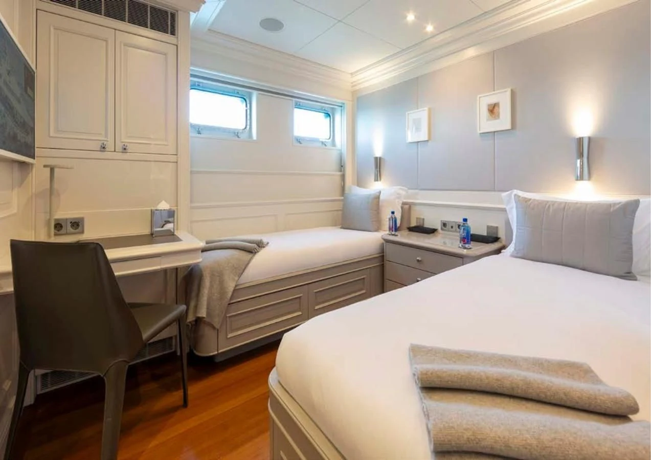 a room with a bed and a desk aboard BRAVADO Yacht for Sale