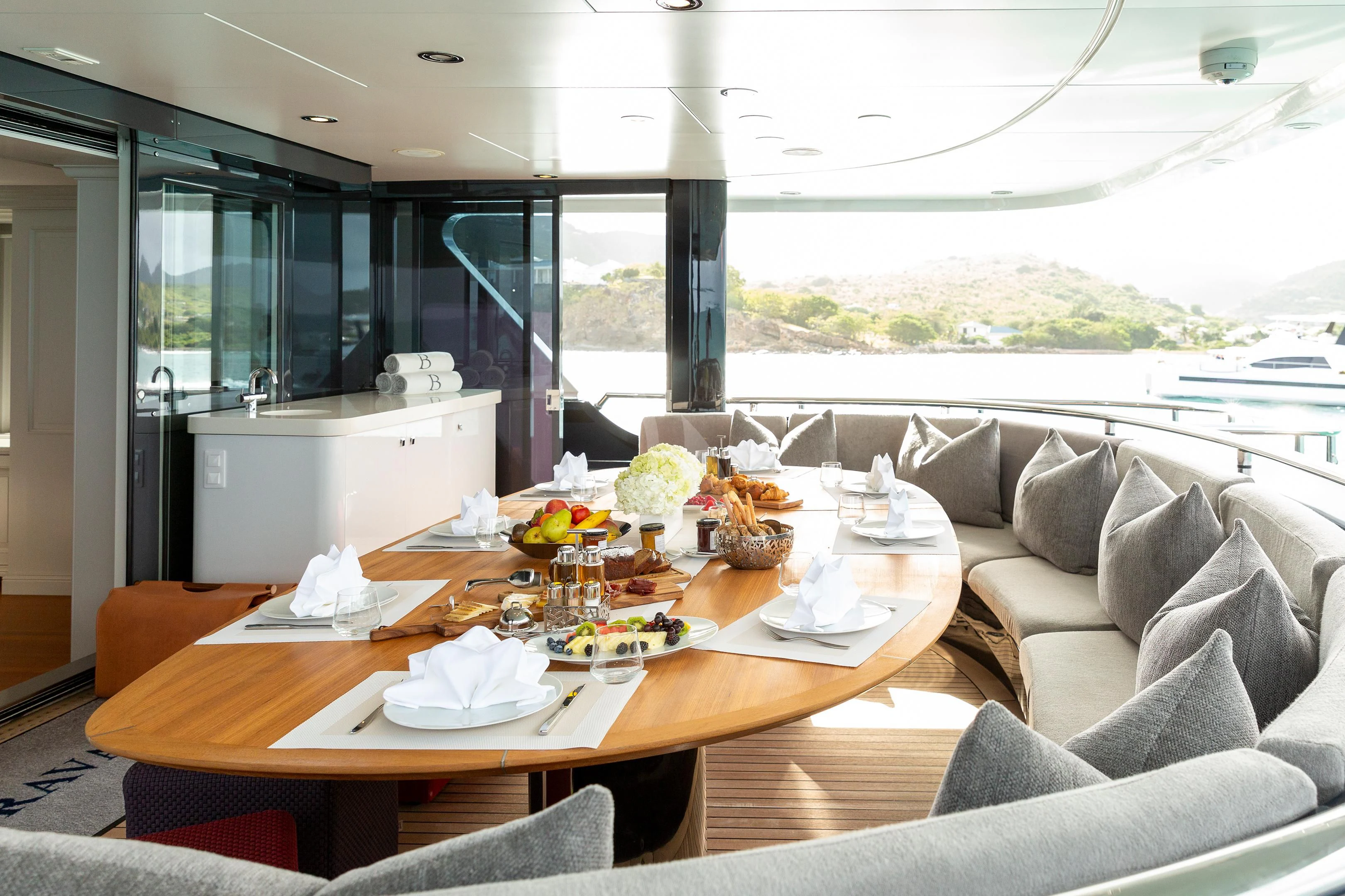 a dining table in a living room aboard BRAVADO Yacht for Sale