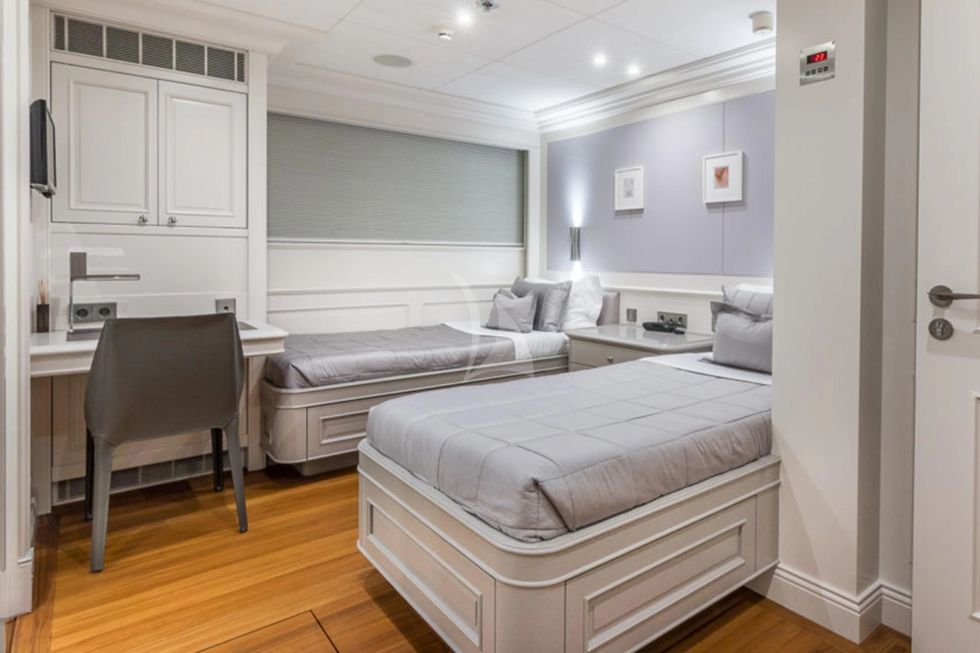 a bedroom with a bed and a chair aboard BRAVADO Yacht for Sale