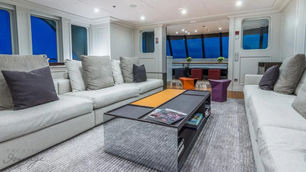 a living room with a couch and a coffee table aboard BRAVADO Yacht for Sale