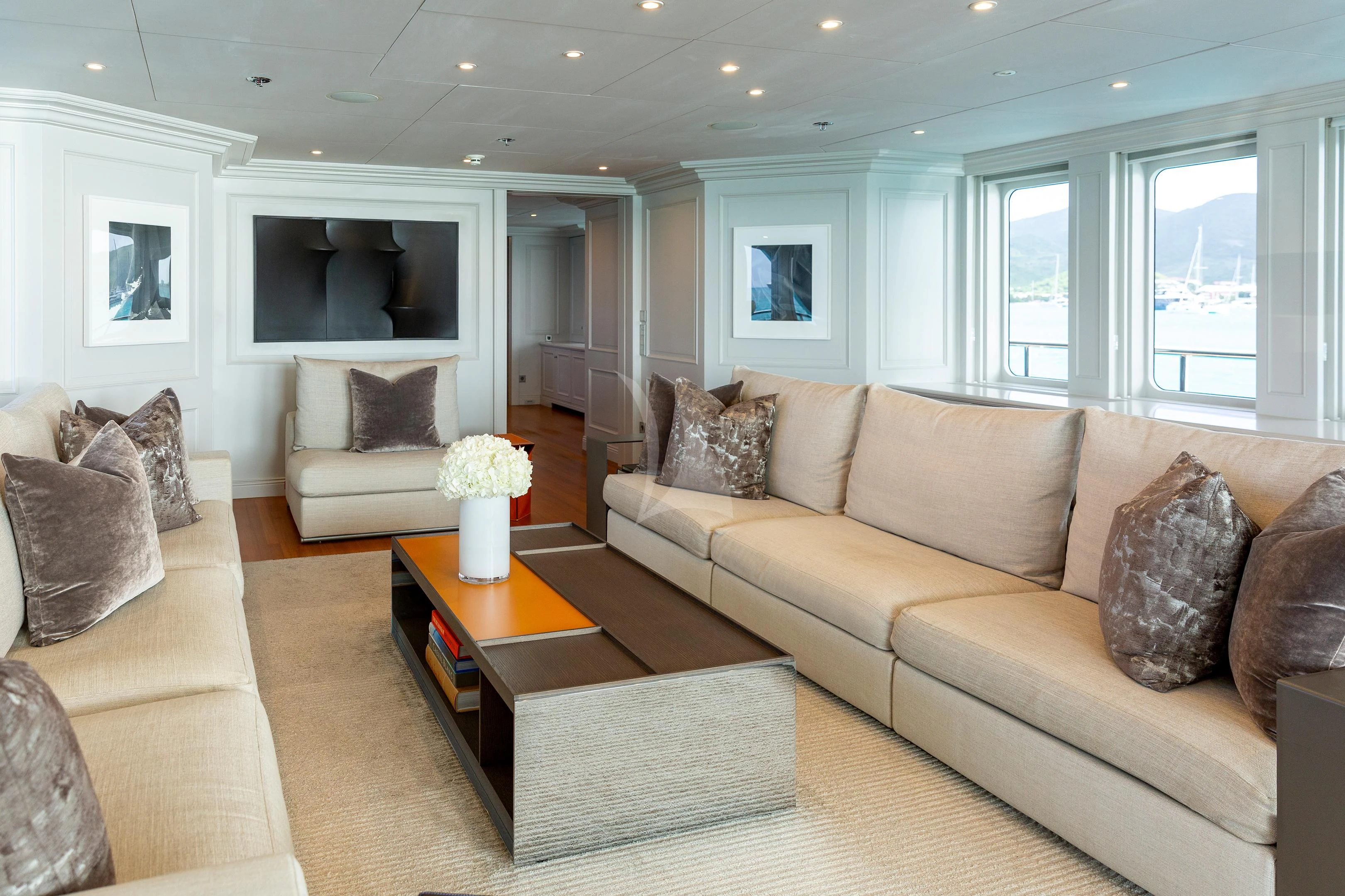 a living room with a couch and a coffee table aboard BRAVADO Yacht for Sale