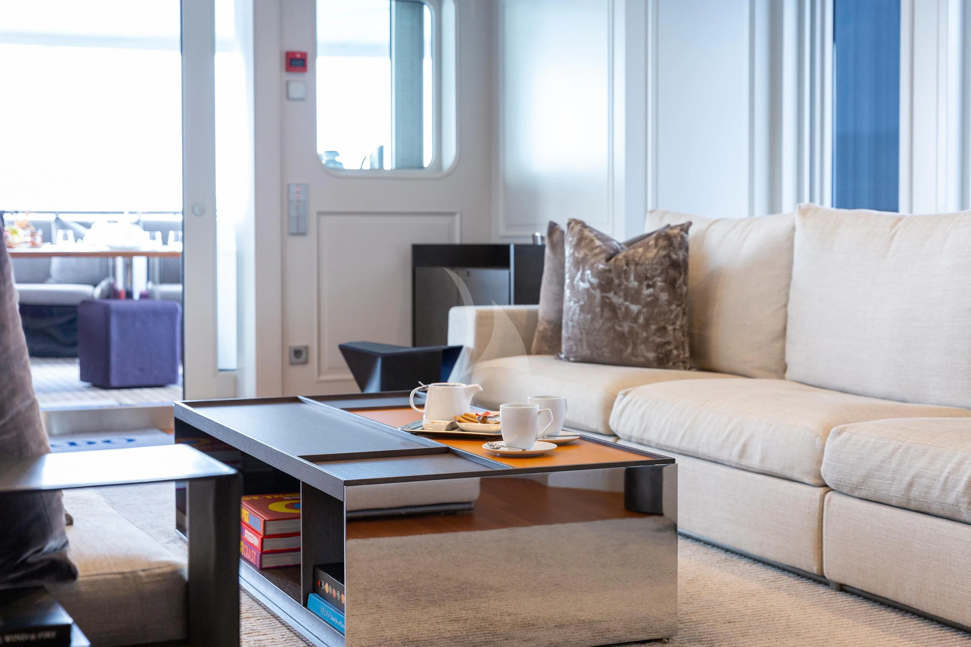 a living room with a couch and coffee table aboard BRAVADO Yacht for Sale
