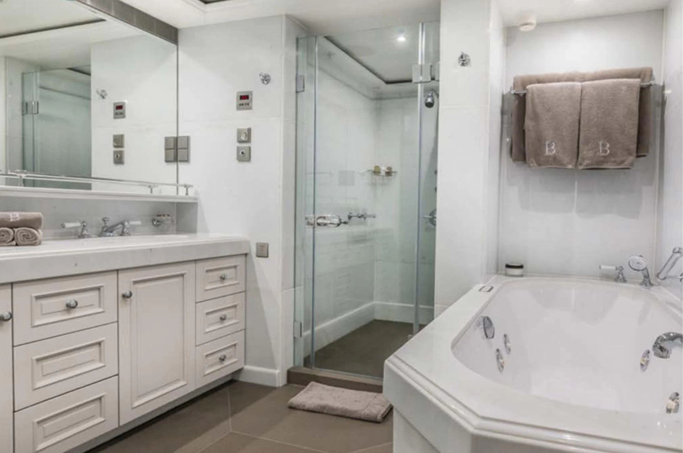 a bathroom with a glass shower aboard BRAVADO Yacht for Sale
