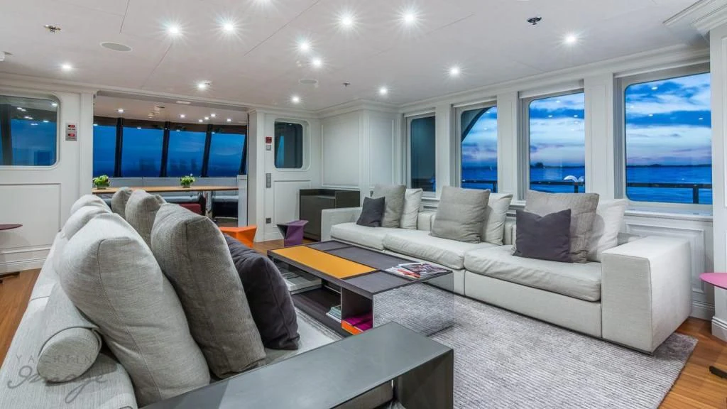 a living room with a large window aboard BRAVADO Yacht for Sale
