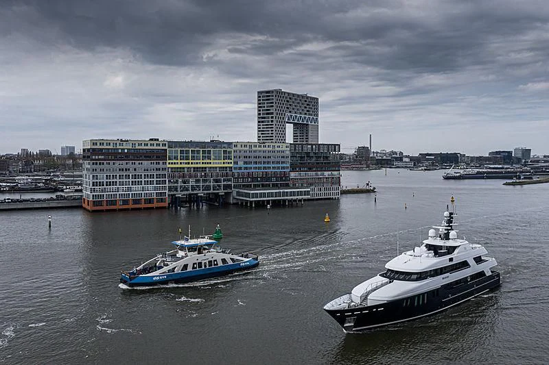 a large ship next to a smaller boat in the water aboard BRAVADO Yacht for Sale