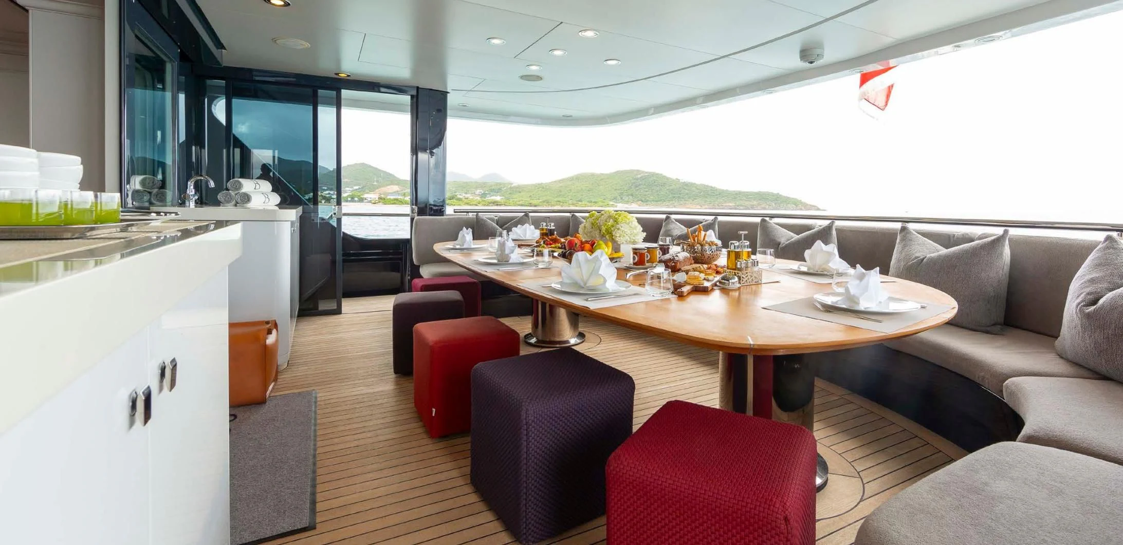 a table with chairs and a couch aboard BRAVADO Yacht for Sale