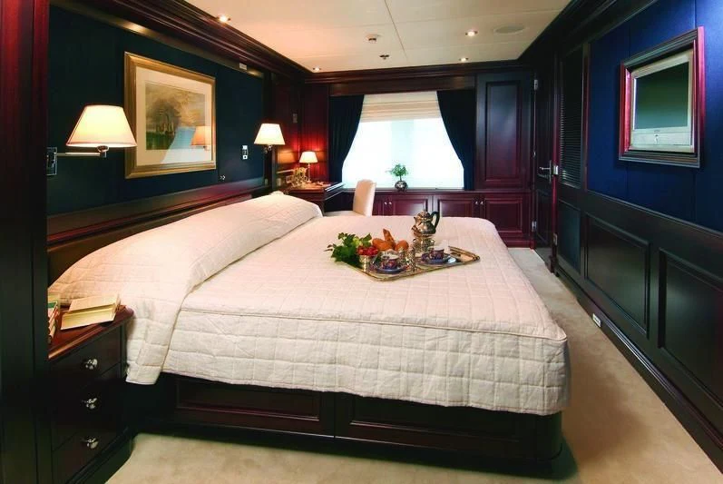 a bed with a tray of food aboard BRAVADO Yacht for Sale