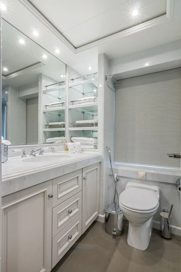 a bathroom with a toilet and a sink aboard BRAVADO Yacht for Sale