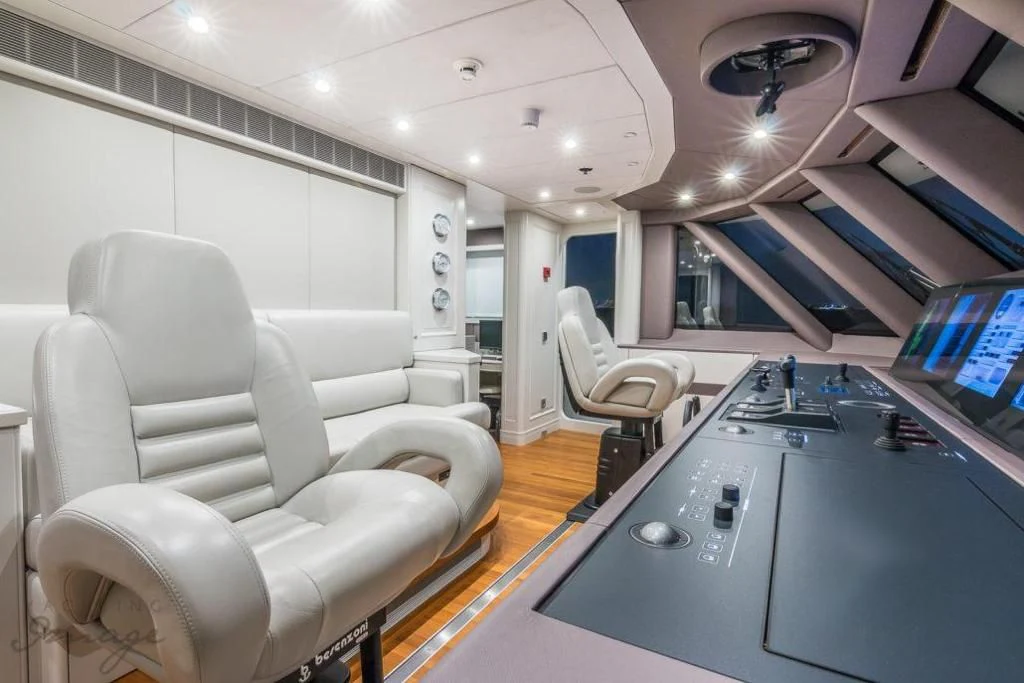 a room with a desk and chairs aboard BRAVADO Yacht for Sale