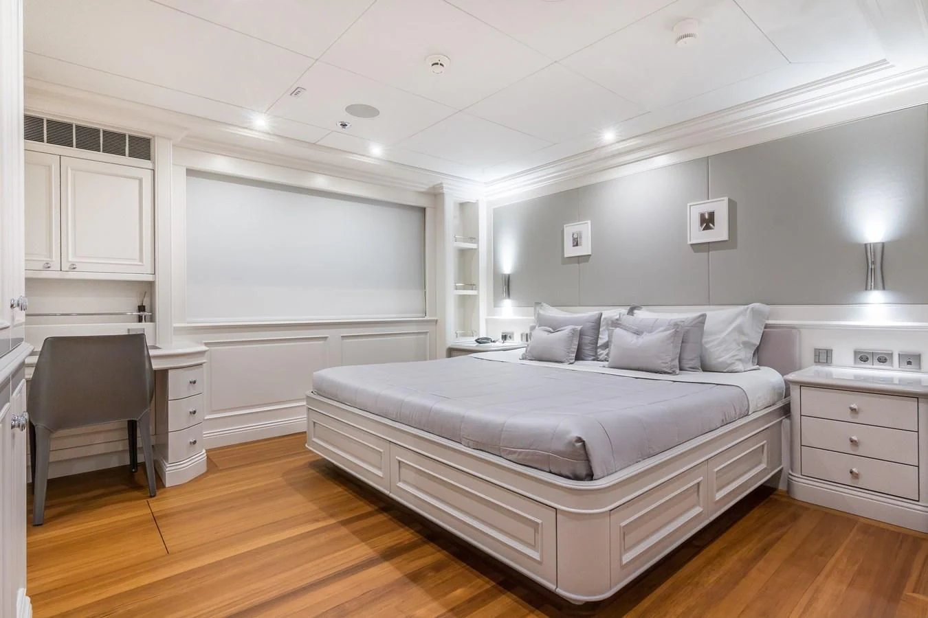 a bedroom with a bed and a desk aboard BRAVADO Yacht for Sale