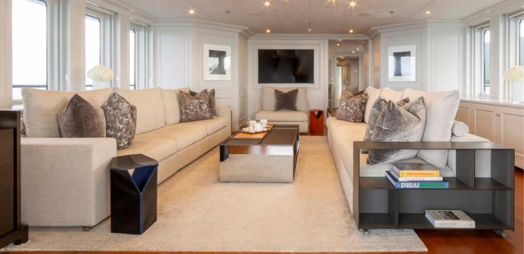 a living room with a couch and a coffee table aboard BRAVADO Yacht for Sale
