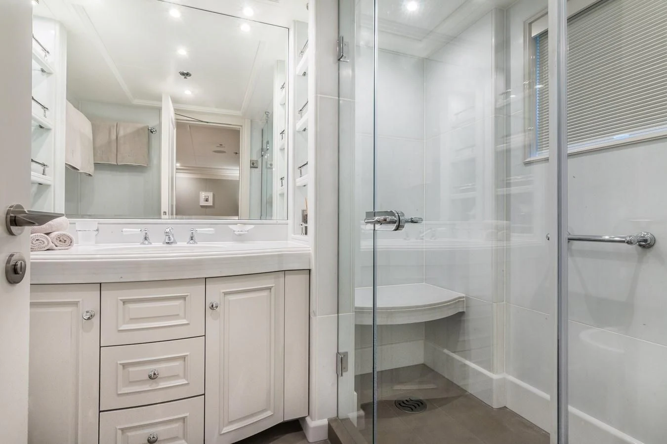 a bathroom with a glass shower aboard BRAVADO Yacht for Sale