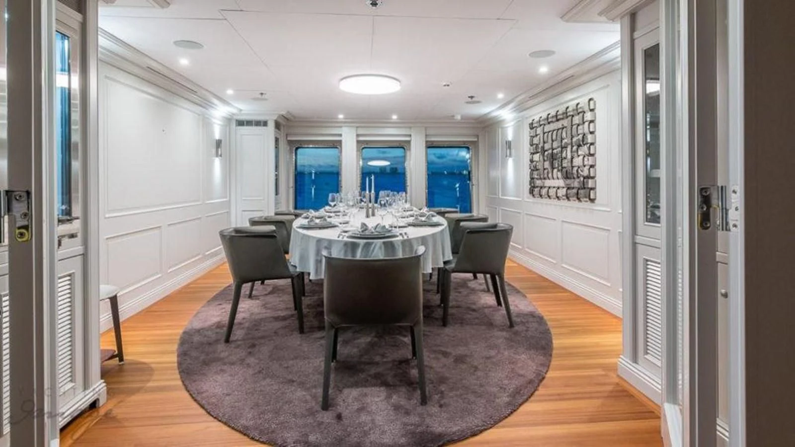 a room with a table and chairs aboard BRAVADO Yacht for Sale