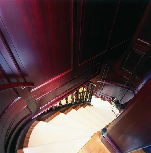 a staircase with a wood railing aboard BRAVADO Yacht for Sale