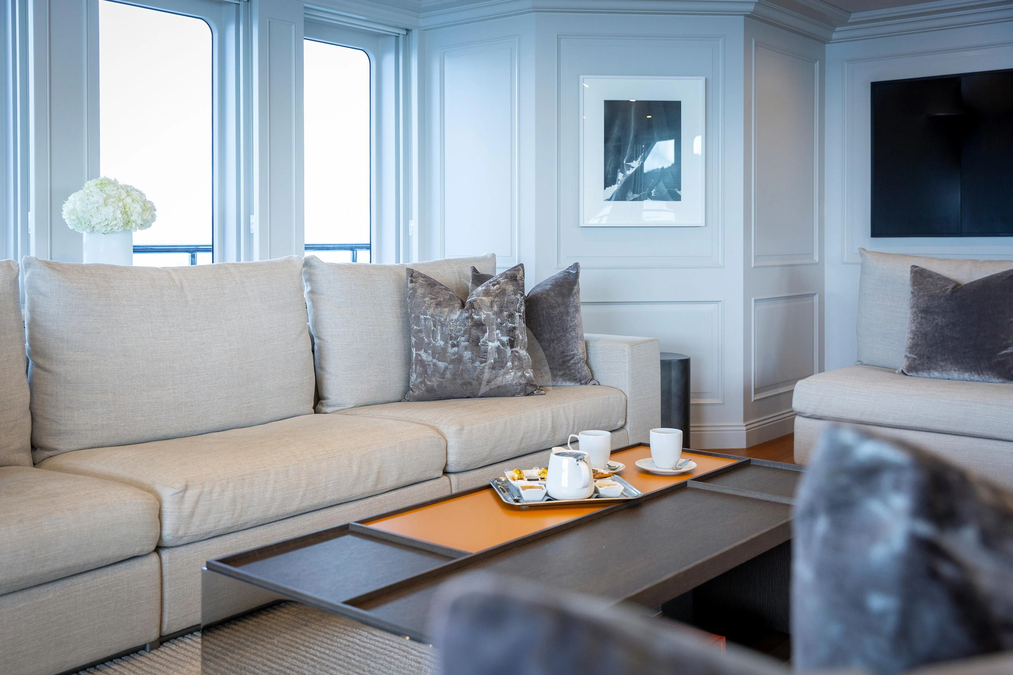a living room with a couch and coffee table aboard BRAVADO Yacht for Sale